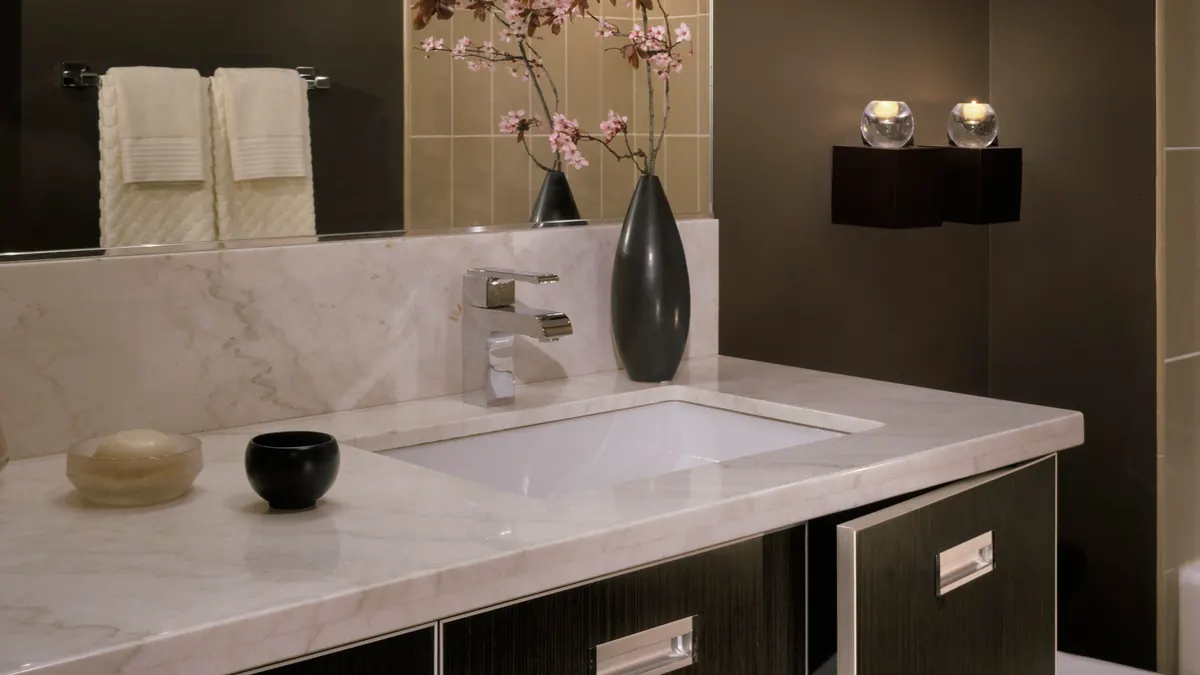 Remodeled bathroom with a tiled walk-in shower, new vanity and porcelain floor in a Greater Boston home
