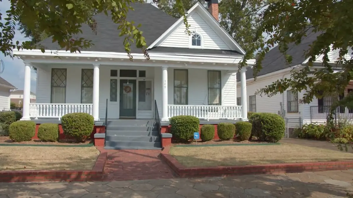 Two-family house with stacked front porches on a residential street in Everett, Massachusetts