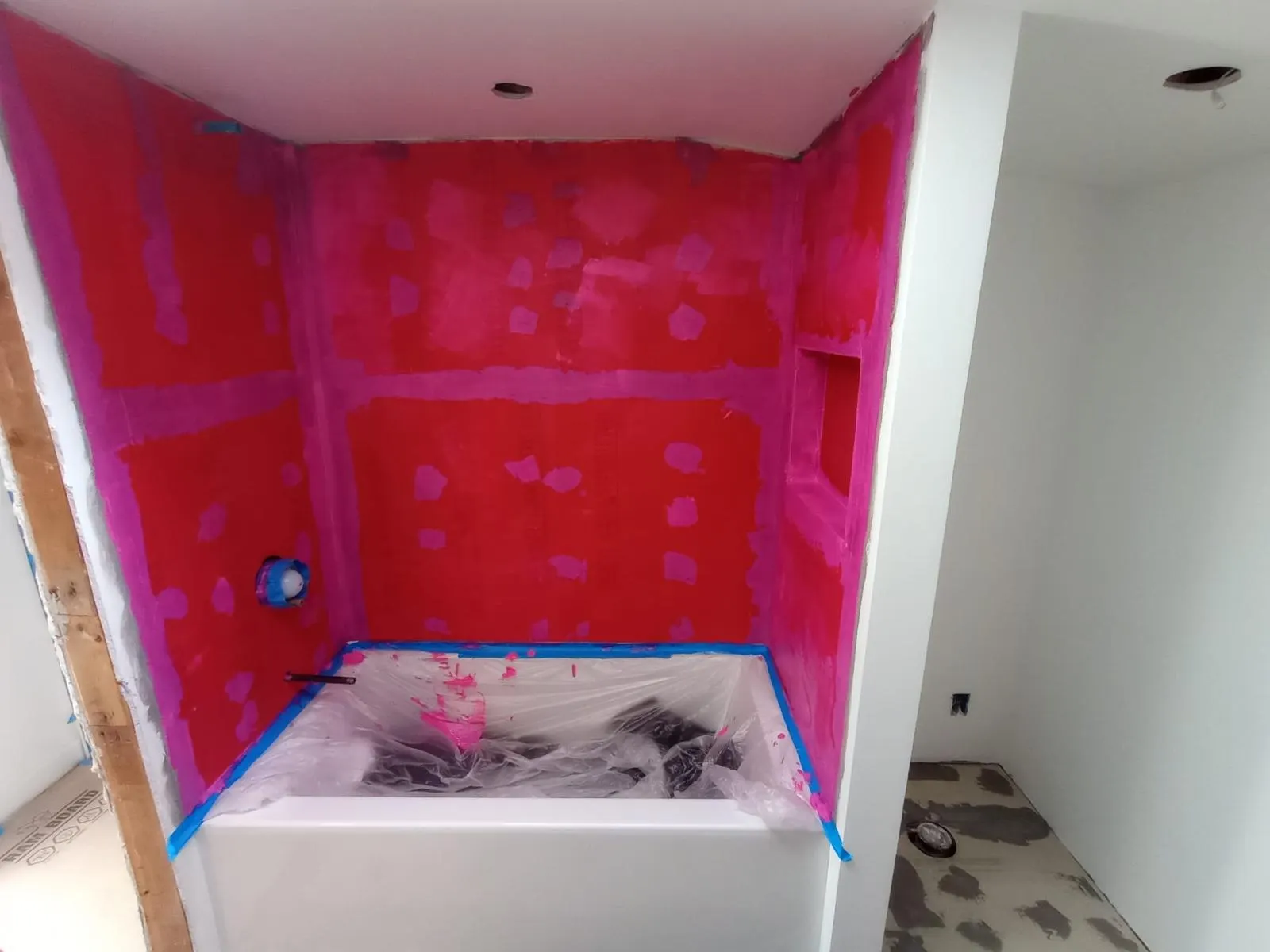 Bathroom shower walls with waterproofing membrane applied before tile